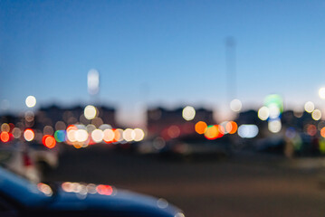 blurred shopping mall parking lot background with lights and cars, Shopping mall outdoor parking lot and bokeh light of retail store in background