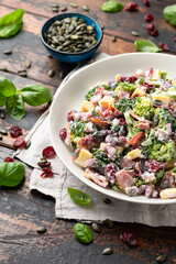 Healthy Homemade Broccoli Salad with bacon, red onion, cranberries, pumpkin seeds and cheese