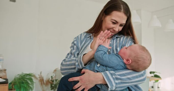 Radiant Mother Smiling at Her Baby while Holding Him Close
