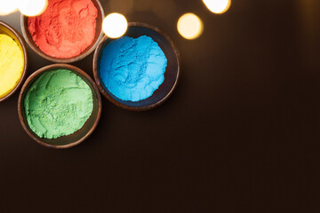 Obraz na płótnie Canvas Closeup view of colorful Holi powder on the bowl
