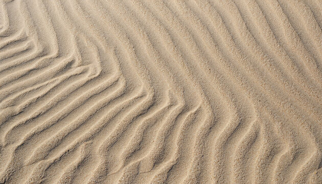 closeup of sand pattern of a beach in the summer with ripple marks; vertical image