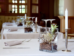 Table set in a restaurant for lunch, noble and cozy ambience with table decoration and candles and lights