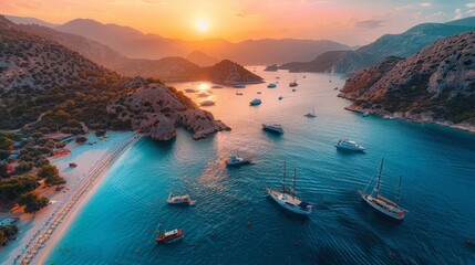 Aerial view of colorful ships parked on the beach in sunset, on the surface of the clear azure sea water in the Mediterranean sea. View from a drone - obrazy, fototapety, plakaty