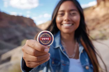 Deurstickers Native American Indian woman holding a voting button © Gary