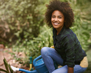 Woman, gardening and portrait with water can, plants and happy for spring, outdoor and earth. Girl, African person and smile on ground for growth, development and nature with ecology in backyard