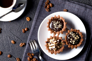 Chocolate baskets with nut cream. Homemade tartlets with cream and glaze