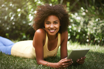 African woman, tablet and portrait on grass to relax, contact and smile for post on web blog. Girl,...