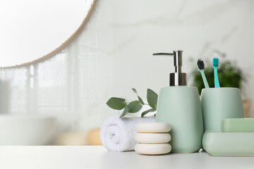 Bath accessories. Different personal care products and eucalyptus leaves on white table in bathroom, space for text