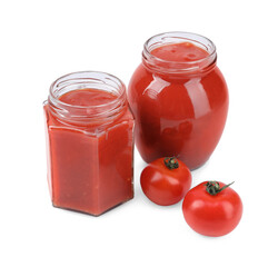 Organic ketchup in glass jars and fresh tomatoes isolated on white. Tomato sauce