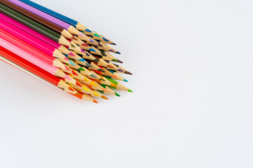 Colorful pencils isolated on white background, back to school, Chipped colored crayons on white background, close up. Colour pencils made craft on the wooden board 