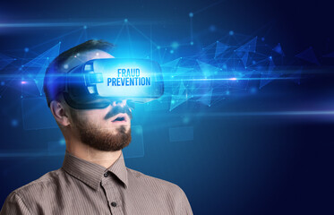 Businessman looking through Virtual Reality glasses, virtual security concept