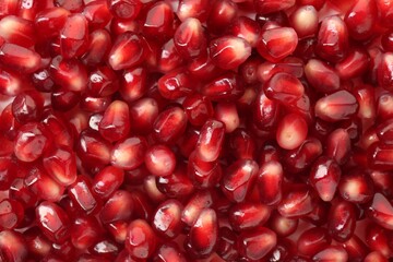 Ripe juicy pomegranate grains as background, top view