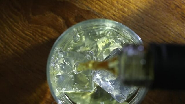 Whisky poured over ice cubes. View from above.