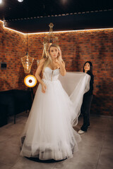 beautiful bride trying on a wedding dress