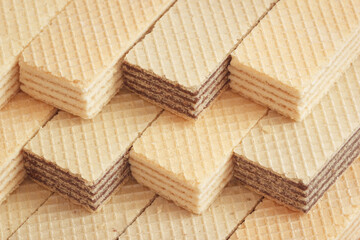 The sweet wafers with vanilla and chocolate flavors. Diagonal arrangements with closeup view.