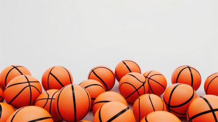 A bunch of orange basketballs are piled up on a white background