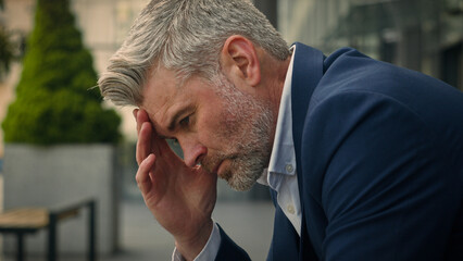 Pensive Caucasian middle-aged old man thinking thoughtful sad unwell anxious senior businessman...
