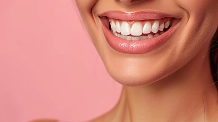 A close-up of a woman flaunting her sparkling clean teeth with a smile, set against a pink backdrop with space for text.