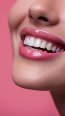 Obraz premium A close-up of a woman flaunting her sparkling clean teeth with a smile, set against a pink backdrop with space for text.