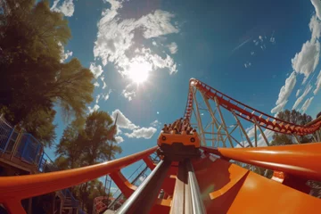 Foto op Plexiglas Dramatic Upward Perspective of Roller Coaster Climb Against Cloudy Sky © Natalia Klenova