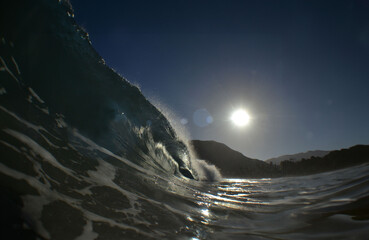 an impressive wave on a beach in the Caribbean Sea