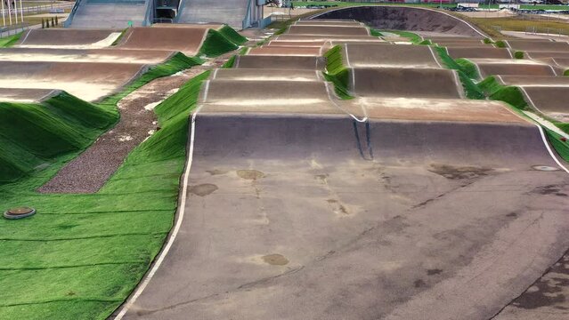 Empty outdoor BMX track in aerial dolly in shot