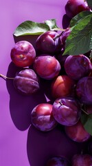 Succulent fresh plums gracefully arranged against a vivid purple background, highlighting their innate beauty. - obrazy, fototapety, plakaty