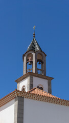 Fototapeta na wymiar Historic Church Bell Tower Against Blue Sky