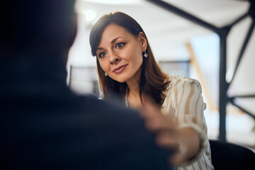 Close-up of a female therapist listening to a male client during psychotherapy. - 756408858