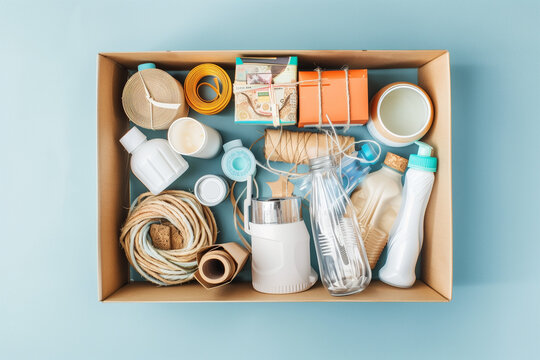 many household goods in a cardboard box on blue background