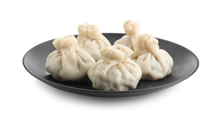 Plate with tasty fresh khinkali (dumplings) and spices isolated on white. Georgian cuisine