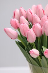 Bouquet of beautiful pink tulips on grey background, closeup