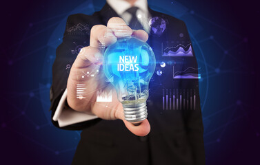 Businessman holding a light bulb, new business concept