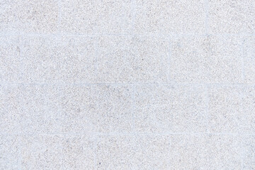 detail of the texture of a wall made with large polished granite blocks - obrazy, fototapety, plakaty