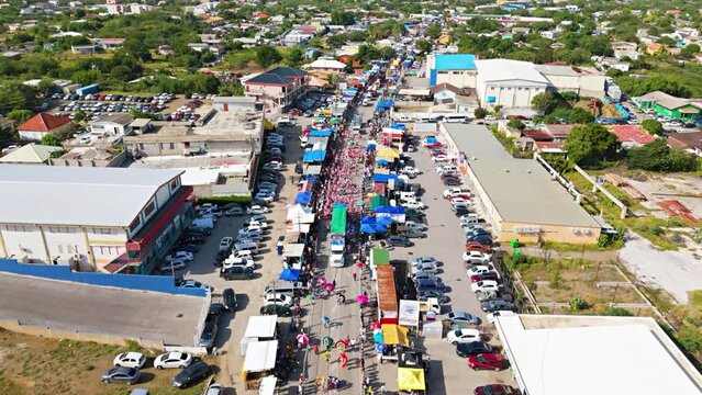 Aerial tilt up to panoramic view of Carnaval Grand March parade in Willemstad Curacao