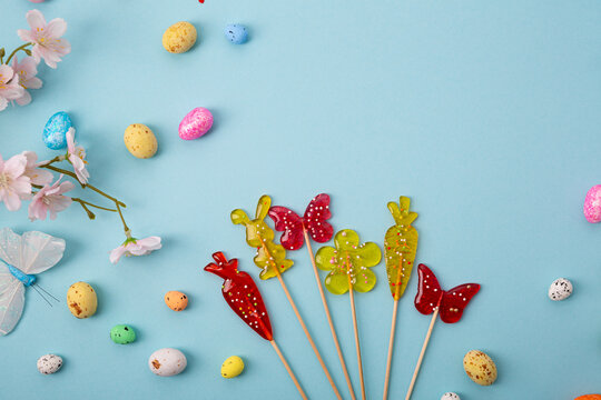 Festive blue Easter holiday background with decorations eggd lolli pops