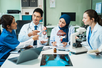 Fototapeta premium A diverse group of healthcare professionals, including doctors, nurses, and specialists, engaging in a collaborative meeting to discuss medical cases and share expertise in a hospital