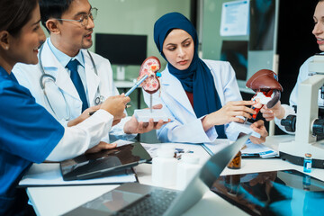 Fototapeta premium A diverse group of healthcare professionals, including doctors, nurses, and specialists, engaging in a collaborative meeting to discuss medical cases and share expertise in a hospital
