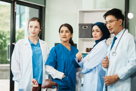 A dedicated team of doctors and healthcare professionals working collaboratively in a hospital setting, ensuring quality patient care with expertise and compassion. Asian, Caucasian and muslim people