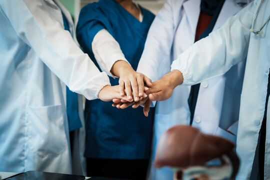 A dedicated team of doctors and healthcare professionals working collaboratively in a hospital setting, ensuring quality patient care with expertise and compassion. - Powered by Adobe