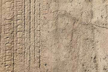 car tire tracks imprint on cracked clay