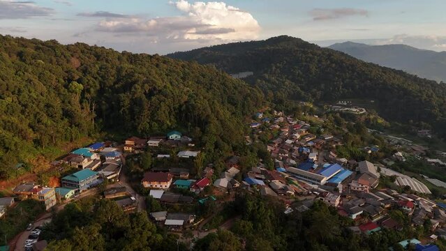 Aerial video of a village in a beautiful valley and forest.