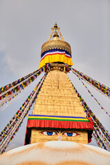 Boudhanath stupa in Kathmandu, Nepal decorated Buddha wisdom eyes and prayer flags, most popular tourist attractions in Kathmandu reflecting harmonious blend of spirituality and tourism