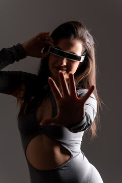 Woman playing and gesturing using virtual reality mixed goggles