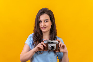 Woman holding a retro camera on hands