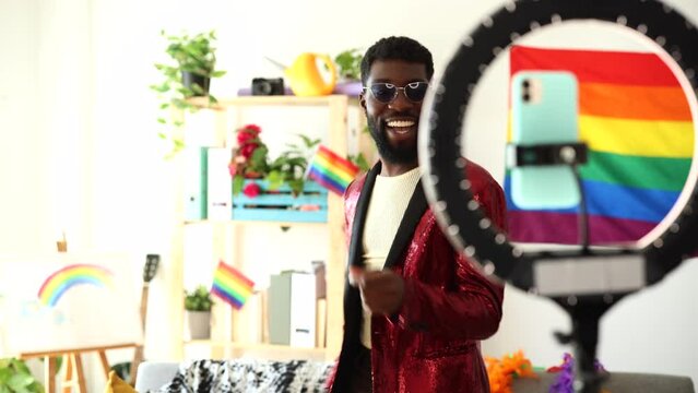 Stylish Man with Sunglasses Dancing at Home. Man in red sequined jacket dancing with joy at home, expressing happiness and style.