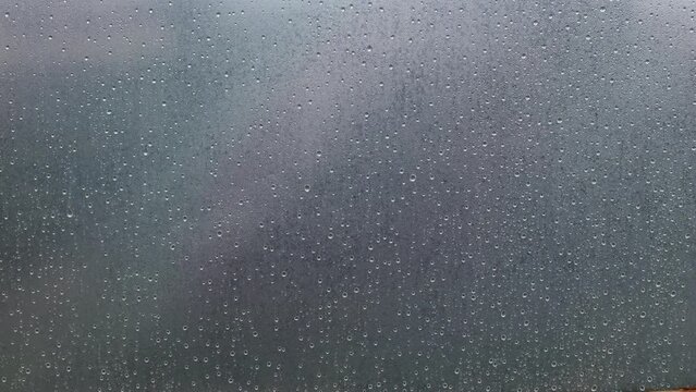 Raindrops on transparent oilcloth. Many drops of water on a transparent background. Condensation in the greenhouse, high humidity