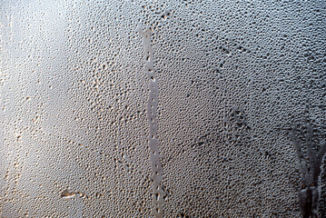 water drops on glass surface close up