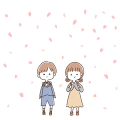 桜が舞う中、ランドセルを背負った小学生の男の子と女の子