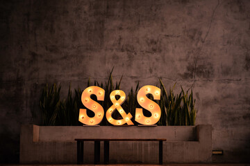 S and S letter lights near a cement wall